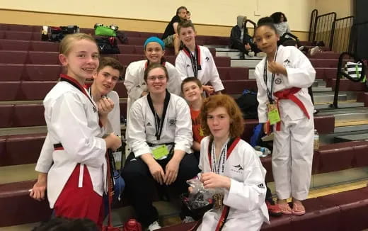 a group of people wearing white karate uniforms