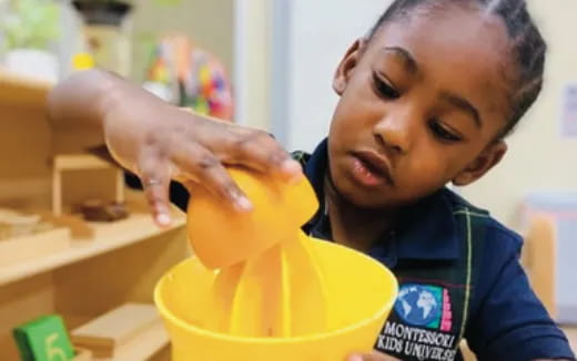 a child opening a yellow bucket