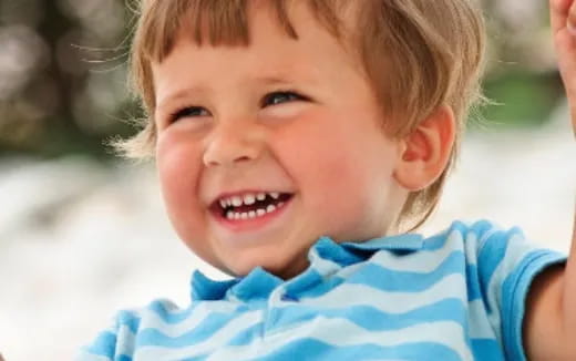 a close-up of a boy smiling