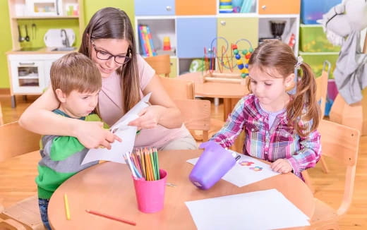 a group of children sitting at a table