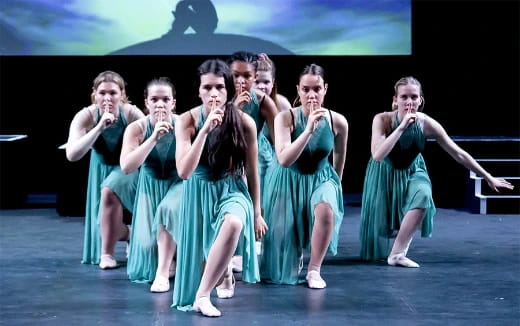 a group of women in green dresses