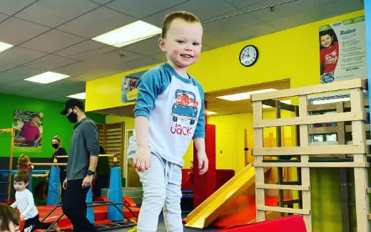 a boy standing in a classroom