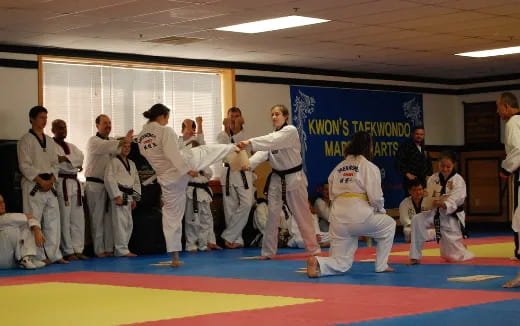 a group of people in karate uniforms