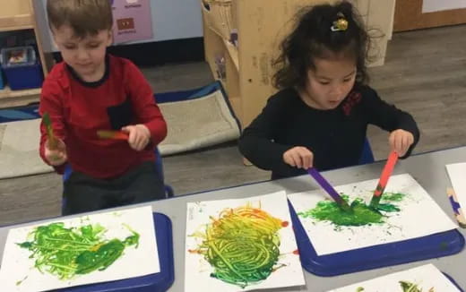 a couple of children painting