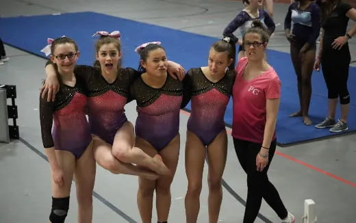 a group of women in swimsuits on a track