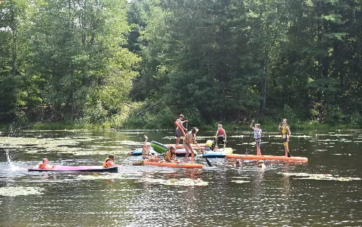 a group of people on canoes in a river