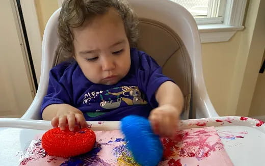 a baby eating a strawberry