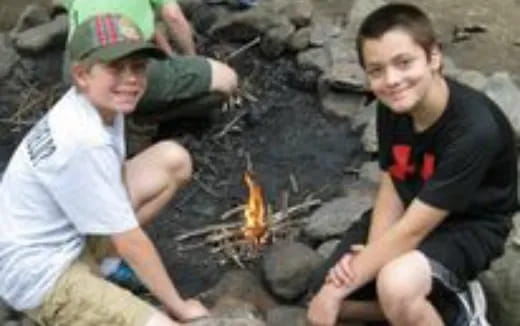 a few men sitting around a fire