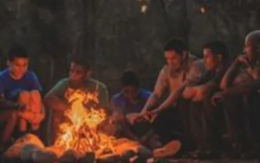 a group of people around a fire