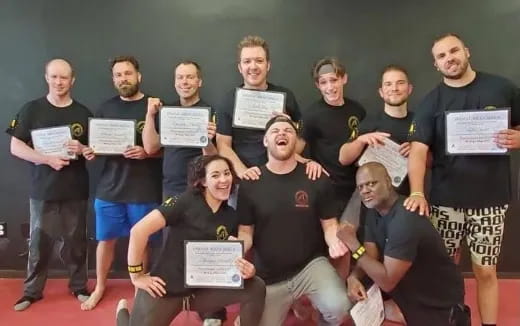 a group of people holding certificates