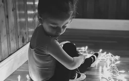 a young boy holding a baby