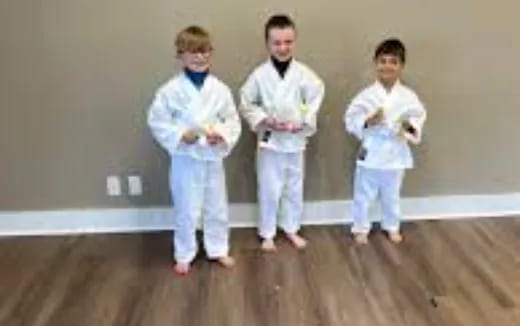 a group of people wearing white karate uniforms