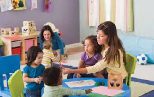 a group of children sitting in a classroom