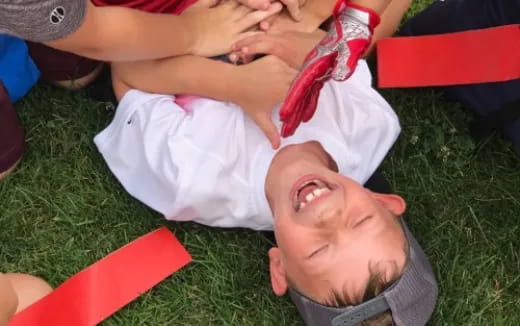 a baby lying on a man's back