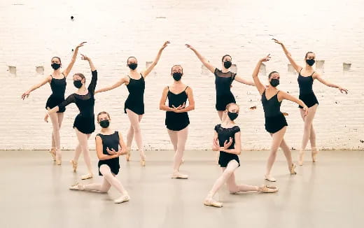 a group of women dancing on a beach