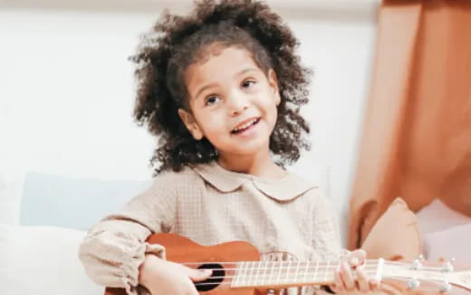 a child playing a guitar