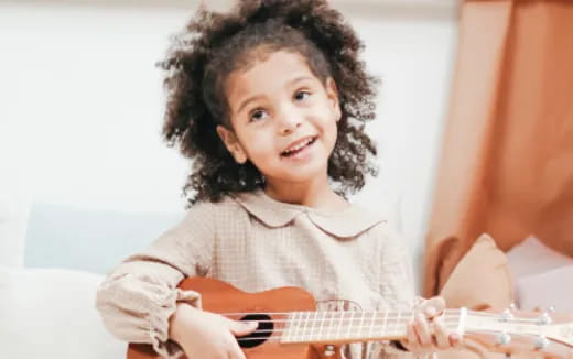 a child playing a guitar