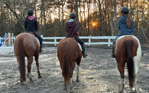 a group of people riding horses