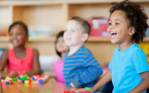 a group of children sitting at a table