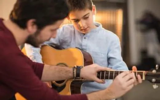 a man playing a guitar
