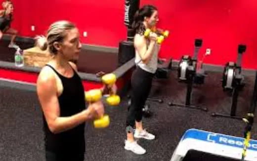 a woman holding a barbell