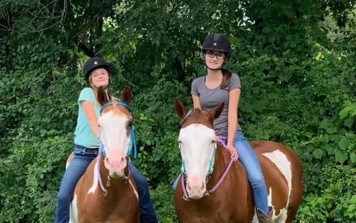 two women riding horses