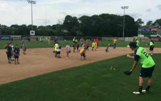 a group of people playing baseball