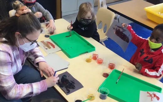 a group of children painting