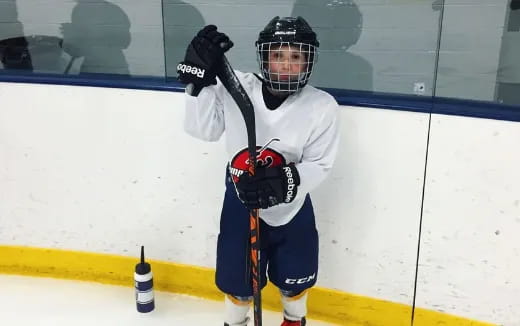 a man wearing a hockey uniform and holding a hockey stick