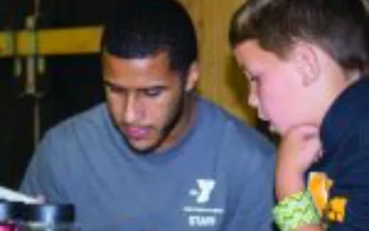 a man with his hand on another man's shoulder