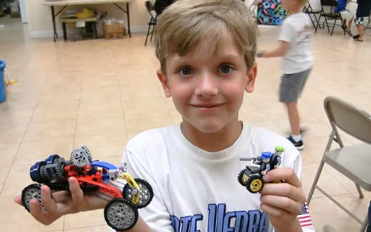 a boy holding toy cars