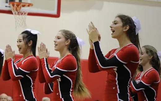 a group of cheerleaders in red and white uniforms