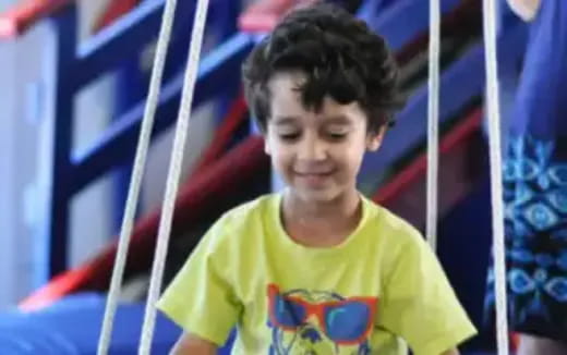 a boy in a yellow shirt