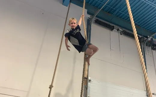 a person climbing a rope