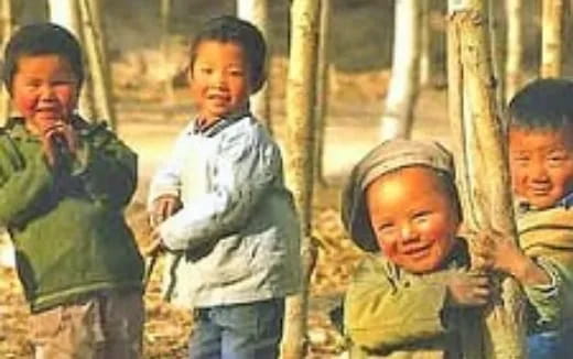 a group of people standing next to a fence