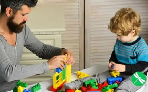 a person and a child playing with toys