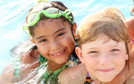 a couple of children in a pool