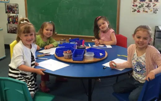 a group of children sitting at a table