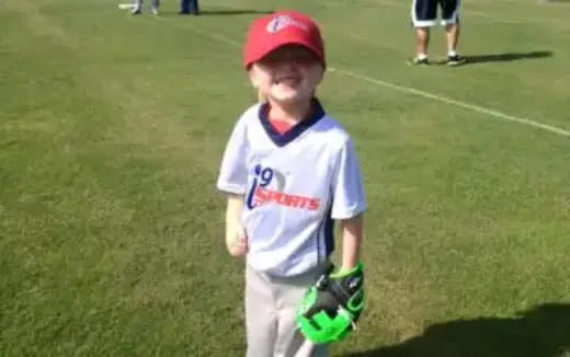 a boy in a baseball uniform