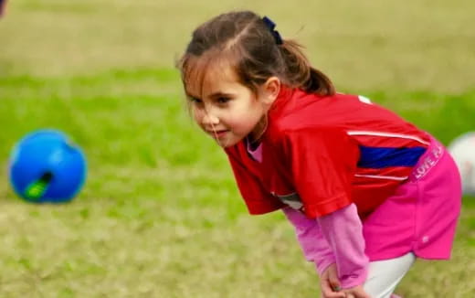 a little girl playing with a ball