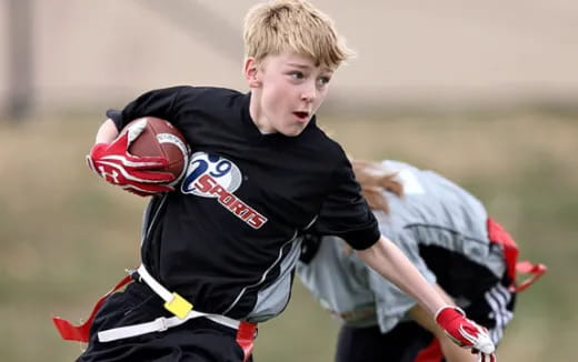 a person wearing a black shirt and holding a red ball