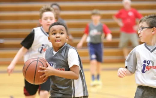 a group of kids playing basketball