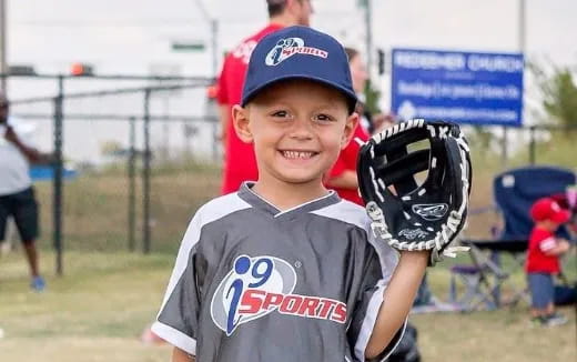 a boy holding a baseball glove