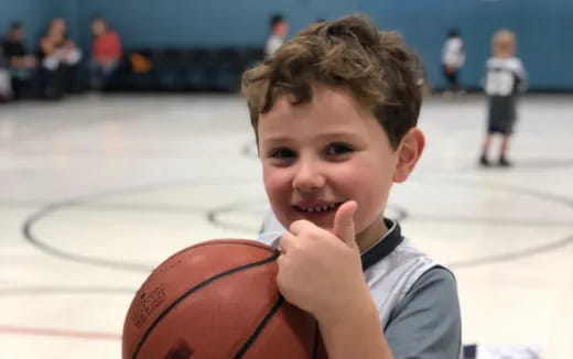 a boy holding a basketball