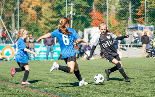 girls playing football on a field