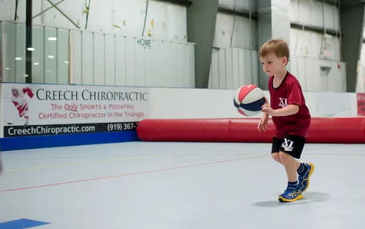 a boy holding a ball