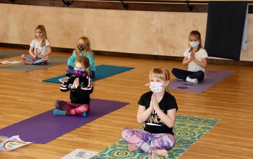 a group of children sitting on mats