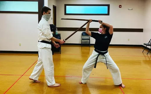 a man and a woman practicing martial arts
