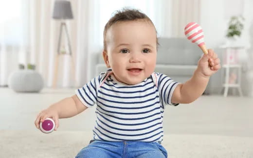 a baby holding a toy