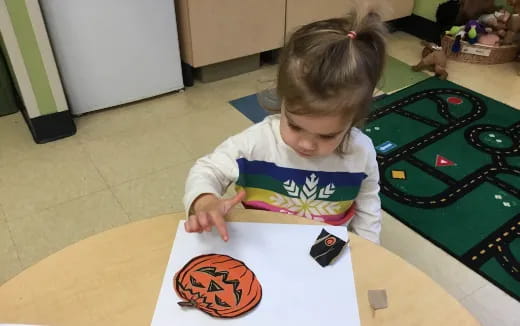 a girl coloring on a paper